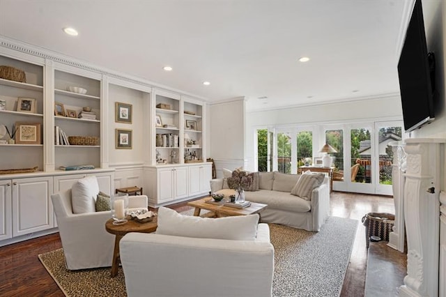 living room with built in features, french doors, crown molding, and dark wood-type flooring