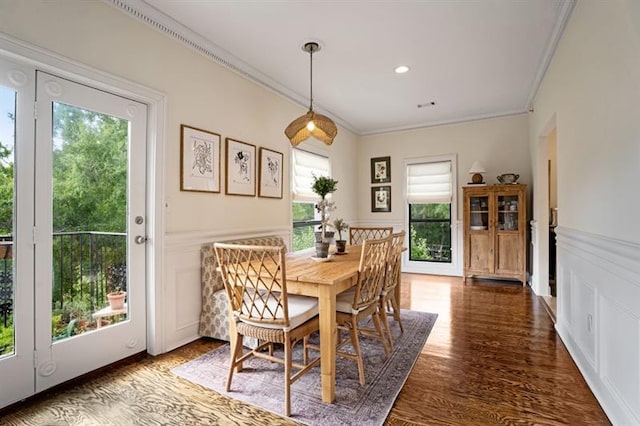 dining area with a wealth of natural light, dark hardwood / wood-style flooring, and crown molding