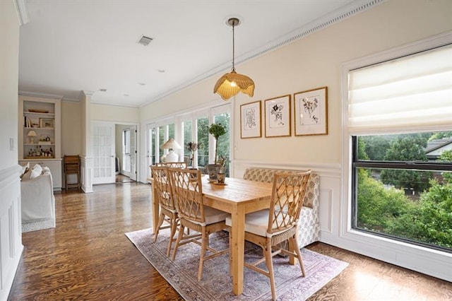 dining area featuring dark hardwood / wood-style floors, ornamental molding, and french doors