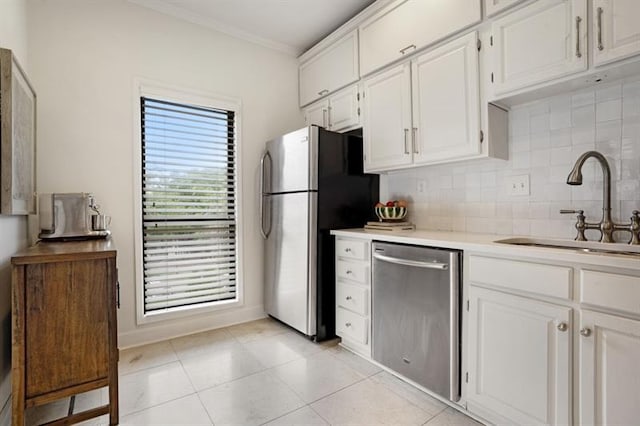 kitchen featuring white cabinets, appliances with stainless steel finishes, backsplash, and sink