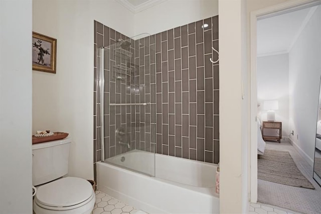 bathroom featuring crown molding, tile patterned flooring, tiled shower / bath combo, and toilet