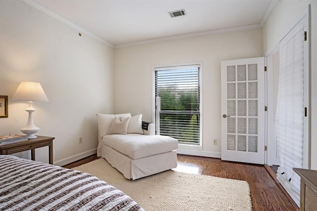 bedroom with dark hardwood / wood-style floors and crown molding