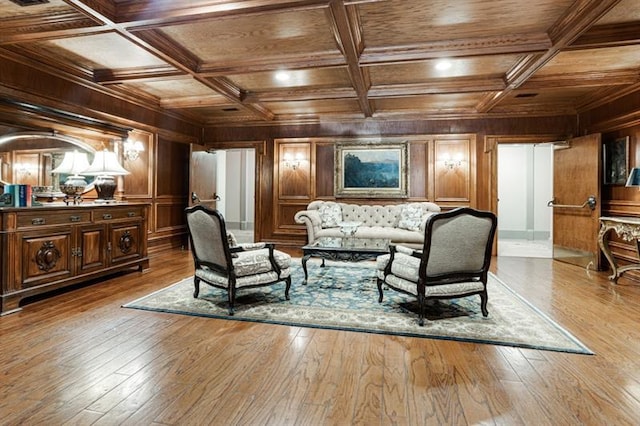 living area featuring wood walls, light wood-type flooring, and coffered ceiling