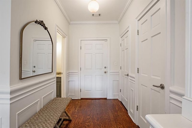 doorway with dark hardwood / wood-style flooring and crown molding