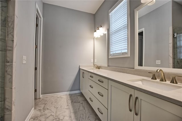 6603 Sterling Dr, Atlanta, GA 30328 - bathroom featuring marble look tiles, double vanity, plenty of natural light, and baseboards
