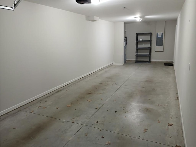 6603 Sterling Dr, Atlanta, GA 30328 - garage featuring electric panel, a garage door opener, and baseboards