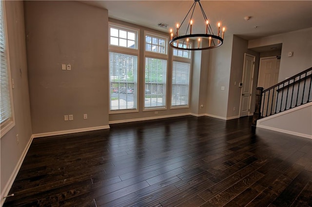 6603 Sterling Dr, Atlanta, GA 30328 - empty room featuring dark wood-style flooring, healthy amount of natural light, a chandelier, and baseboards