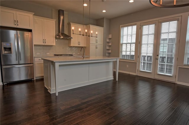 6603 Sterling Dr, Atlanta, GA 30328 - kitchen featuring stainless steel fridge with ice dispenser, wall chimney exhaust hood, light countertops, a chandelier, and white cabinetry