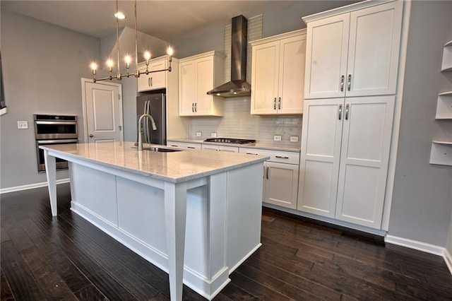 6603 Sterling Dr, Atlanta, GA 30328 - kitchen featuring wall chimney exhaust hood, a sink, stainless steel appliances, a kitchen island with sink, and dark wood-style floors
