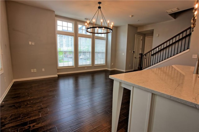 6603 Sterling Dr, Atlanta, GA 30328 - unfurnished dining area featuring dark wood-type flooring, baseboards, a chandelier, and stairs