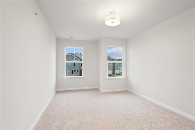 spare room with light colored carpet