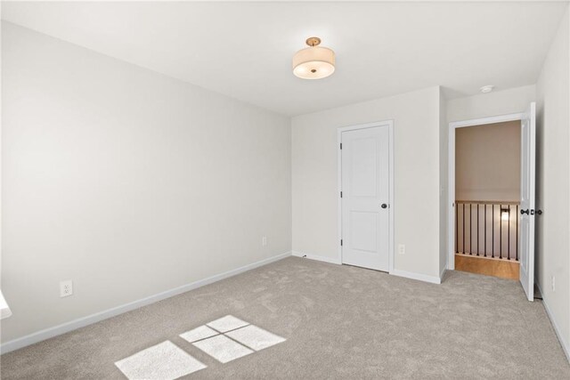 unfurnished room with light carpet