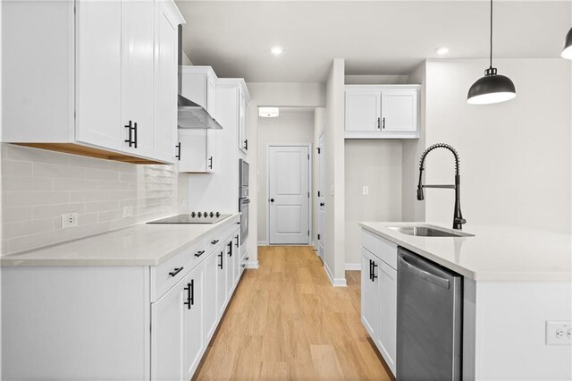 unfurnished living room featuring sink, light hardwood / wood-style floors, and ceiling fan