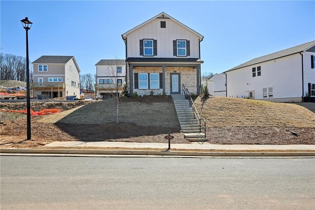 view of front of home with board and batten siding, a residential view, and covered porch