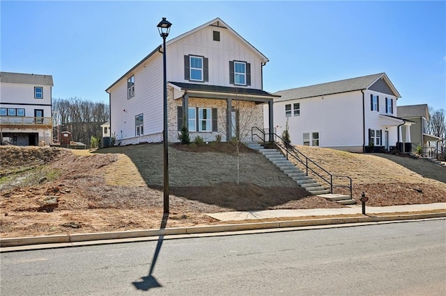 traditional-style house with stone siding and board and batten siding