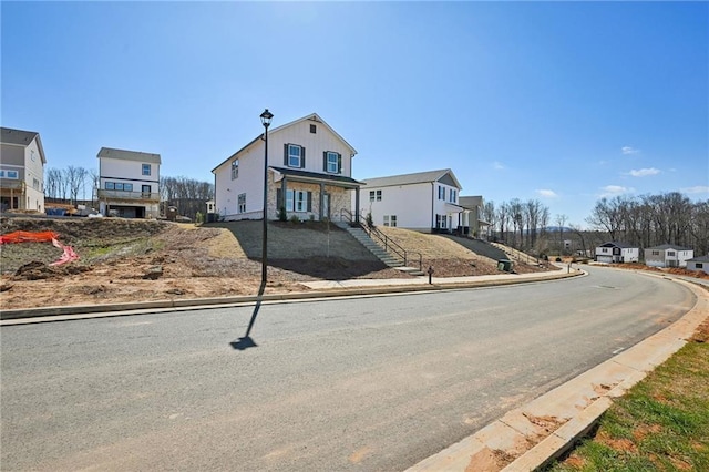 view of street featuring a residential view, street lights, and curbs