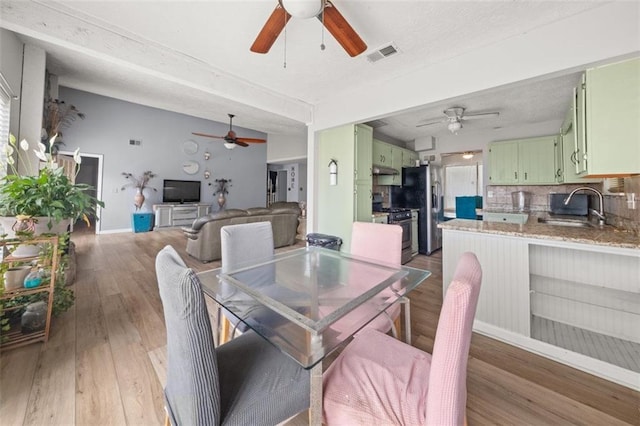 5016 Comanche Ct NW, Lilburn, GA 30047 - dining space featuring a ceiling fan and light wood-type flooring