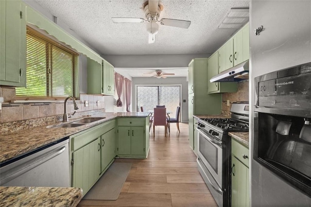 5016 Comanche Ct NW, Lilburn, GA 30047 - kitchen featuring green cabinets, appliances with stainless steel finishes, under cabinet range hood, ceiling fan, and light wood-type flooring