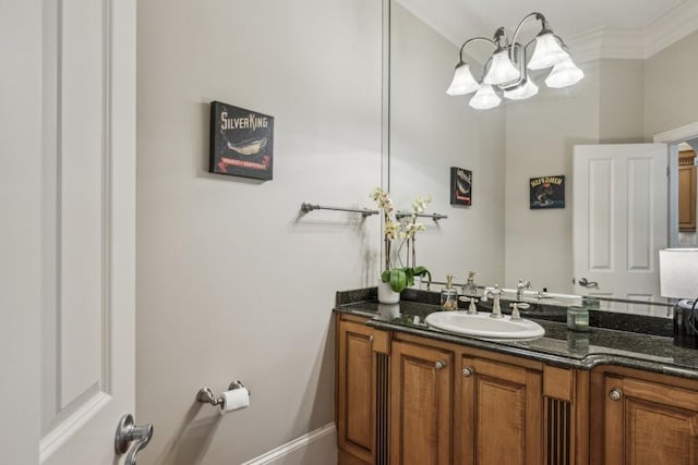 bathroom featuring a chandelier, vanity, and ornamental molding