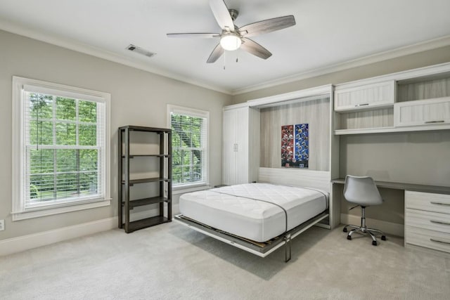 bedroom with light colored carpet, a desk, crown molding, baseboards, and a ceiling fan