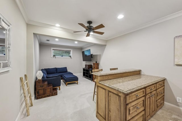kitchen featuring brown cabinetry, ornamental molding, ceiling fan, recessed lighting, and open floor plan