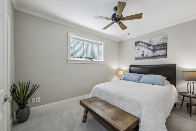 carpeted bedroom featuring baseboards, crown molding, and a ceiling fan