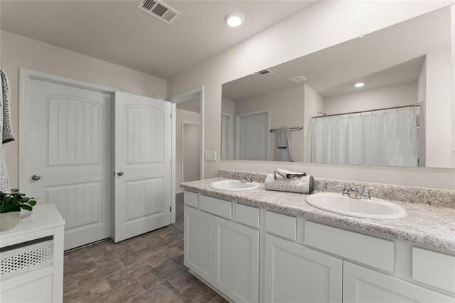 867 Starbuck Pkwy, Pendergrass, GA 30567 - full bathroom featuring a sink, double vanity, recessed lighting, and a bath