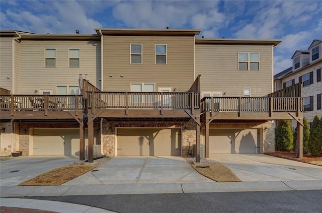 exterior space with a garage and a wooden deck