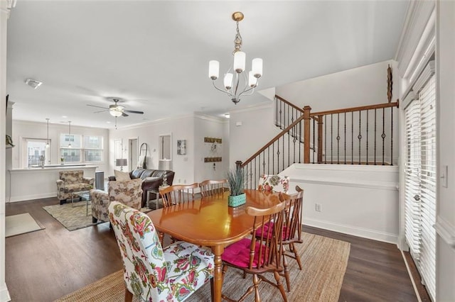 dining room with crown molding, ceiling fan with notable chandelier, and dark hardwood / wood-style floors