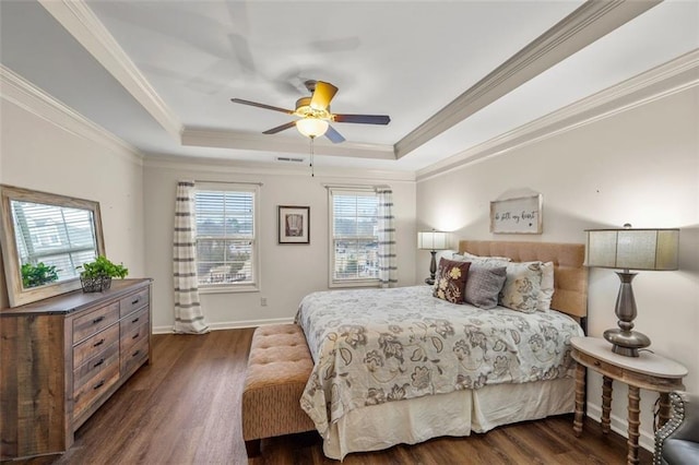 bedroom featuring crown molding, ceiling fan, dark hardwood / wood-style flooring, and a tray ceiling