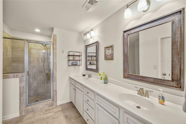 bathroom featuring vanity and a shower with shower door