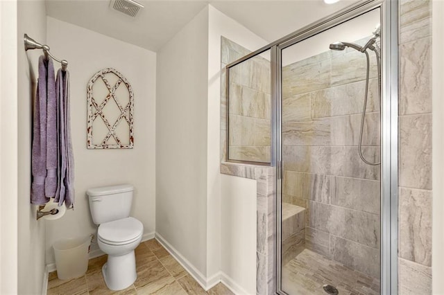 bathroom with a shower with door and toilet