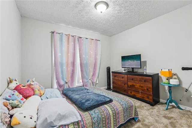 carpeted bedroom featuring a textured ceiling and baseboards