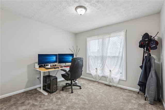 office space featuring visible vents, a textured ceiling, baseboards, and carpet