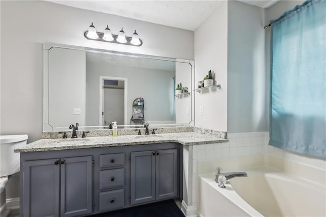 bathroom featuring a sink, toilet, a bath, and double vanity