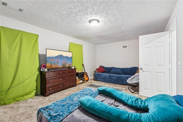 carpeted bedroom with visible vents and a textured ceiling