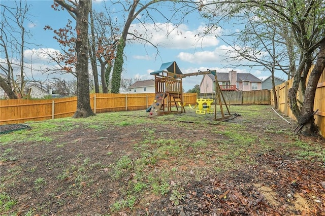 view of yard featuring a playground and a fenced backyard