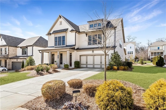 view of front of property with a front yard and a garage