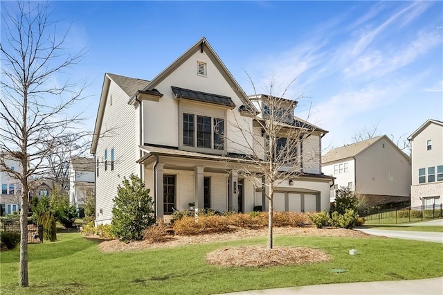 view of front of house featuring a front lawn and a garage