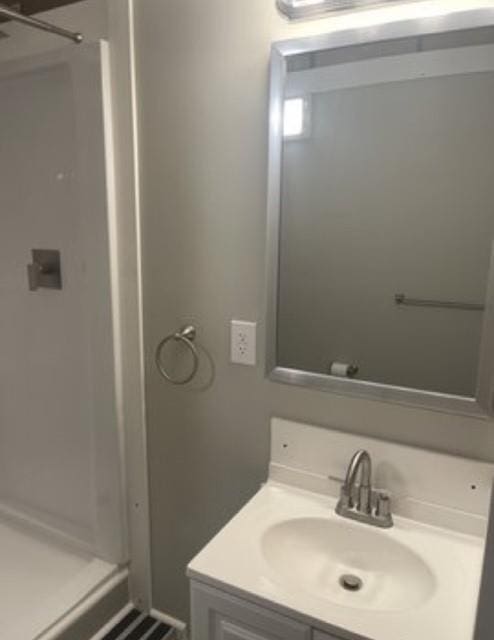 bathroom featuring vanity and a shower