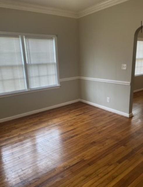 spare room featuring crown molding and dark hardwood / wood-style floors