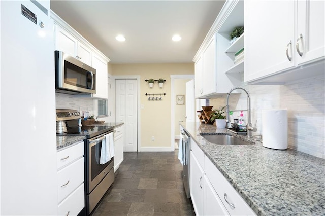 kitchen featuring light stone counters, sink, white cabinets, and appliances with stainless steel finishes