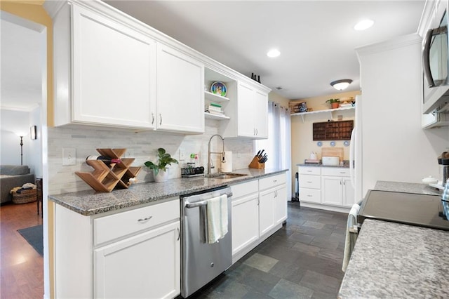 kitchen with dishwasher, sink, backsplash, dark stone counters, and white cabinets