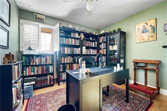 office area with hardwood / wood-style floors and ceiling fan