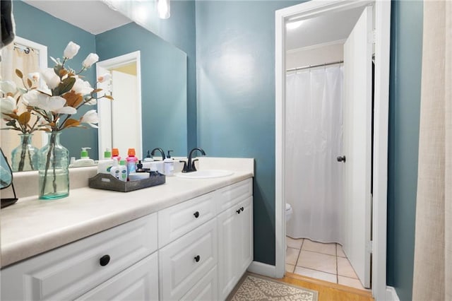 bathroom featuring tile patterned floors, vanity, and toilet