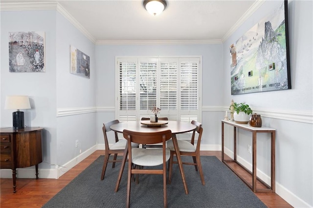 dining space featuring wood-type flooring and crown molding