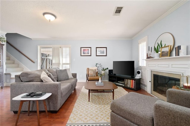 living room featuring hardwood / wood-style flooring and crown molding