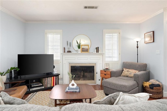 living room with hardwood / wood-style flooring, a wealth of natural light, and crown molding