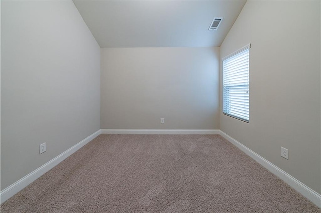 carpeted empty room with lofted ceiling