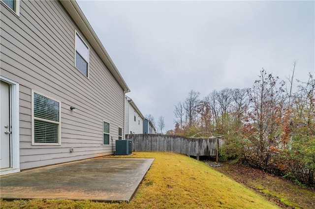 view of yard featuring a patio and central AC unit